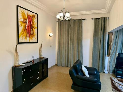 a living room with a couch and a chair at Villa charden pharell in Pointe-Noire