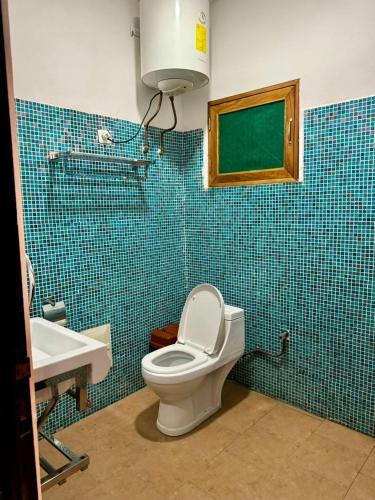 a bathroom with a toilet and a sink at Villa charden pharell in Pointe-Noire