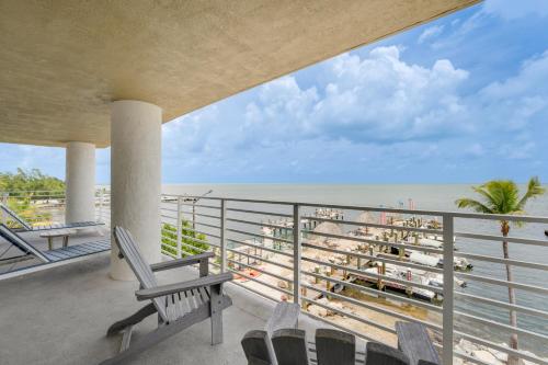 a balcony with chairs and a view of the beach at Hadley Resort and Marina in Islamorada