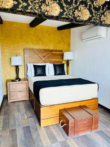a bedroom with a large bed and two lamps at Hotel Boutique La Mansión Guadalajara in Guadalajara