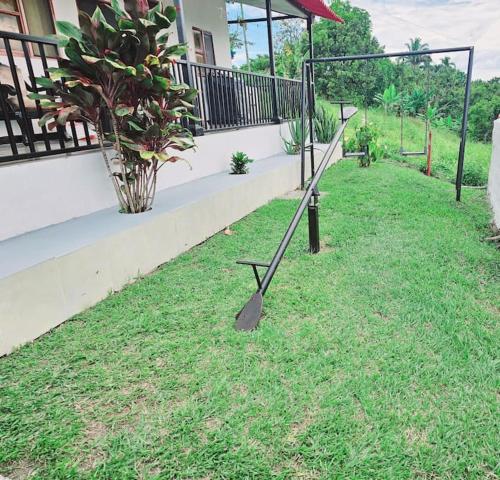 a metal object sitting in the grass next to a house at Finca Hotel VILLA SOFIA in Montenegro