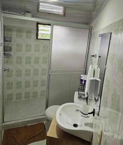 a bathroom with a white sink and a toilet at Finca Hotel VILLA SOFIA in Montenegro