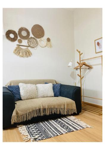a living room with a couch in a room at Bohemian Inspired Studio Unit1 at Trees Residences in Manila