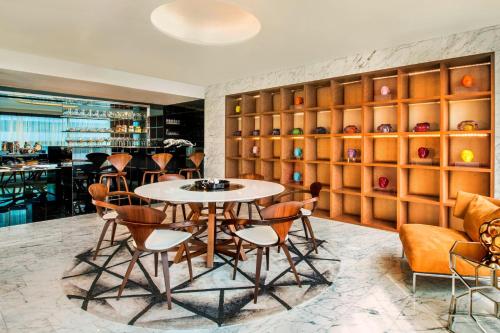a dining room with a table and chairs at W Bangkok Hotel in Bangkok