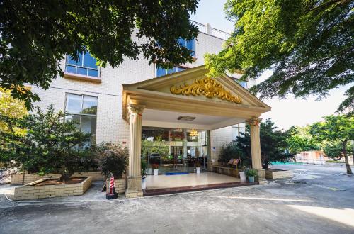 a building with a gazebo in front of it at 小红马民宿 in Yinzhan'ao