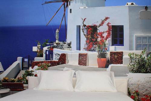 a bed with white pillows in front of a building at Furadouro Terrace Hostel in Furadouro
