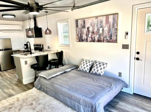 a bedroom with a bed and a kitchen with a counter at Romantic Chapel Hill Retreat for Two in Chapel Hill