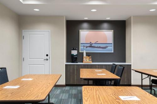 a dining room with tables and a picture of a boat on the wall at Residence Inn by Marriott Milwaukee West in Wauwatosa