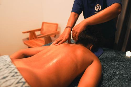 a woman getting her hair cut by a beautician at Bhalance Retreat in Padangbai
