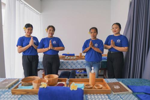a group of people standing in a room with their hands up at Bhalance Retreat in Padangbai