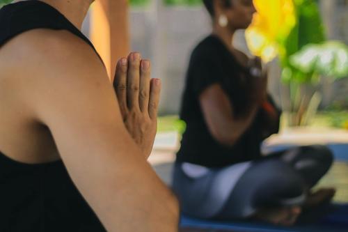 a woman with her hands in the air at Bhalance Retreat in Padangbai