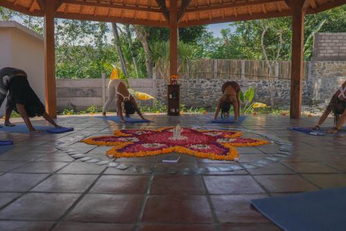 a group of people doing a yoga pose on a floor at Bhalance Retreat in Padangbai