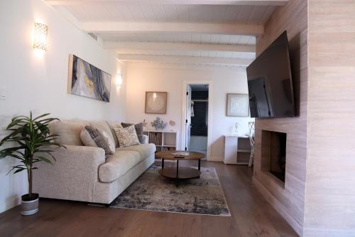 a living room with a couch and a flat screen tv at La Jolla Beach Villa Gem in San Diego
