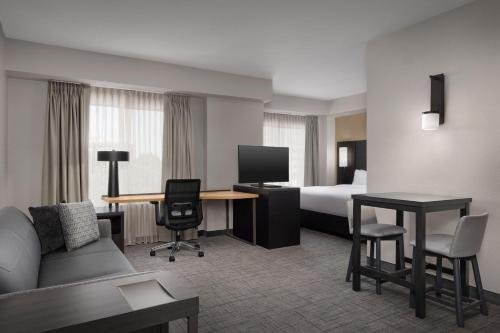 a hotel room with a bed and a desk at Residence Inn Charlotte SouthPark in Charlotte