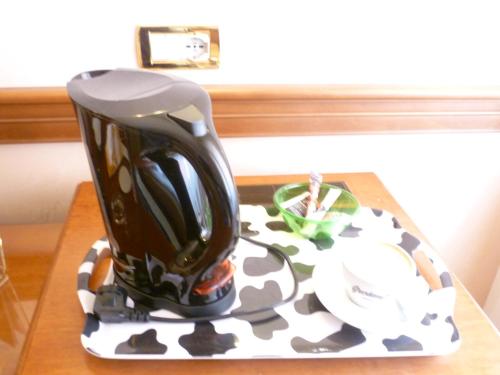 a coffee pot sitting on top of a table at Hotel Minerva in Pordenone