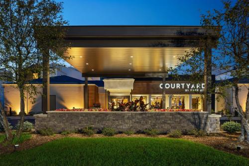 a store front of a building with flowers in front at Courtyard by Marriott Chicago Waukegan / Gurnee in Waukegan