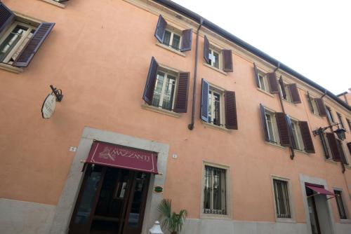 a large orange building with a sign on it at Albergo Mazzanti in Verona