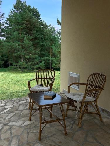 two chairs and a coffee table on a patio at Vila Vera in Divčibare