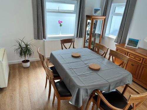 a dining room with a blue table and chairs at Sennen Cove Cottage in Sennen Cove