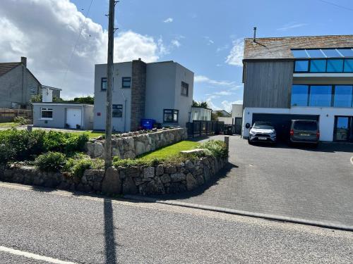 a car parked in a parking lot next to a building at Sennen Cove Cottage in Sennen Cove