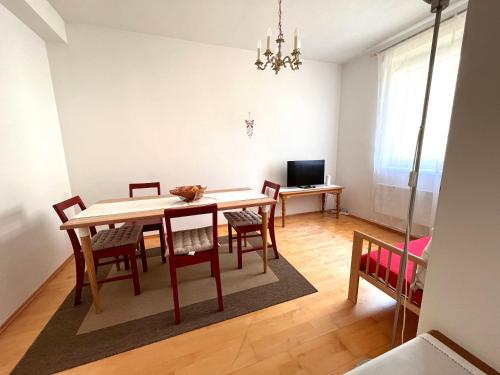 a dining room with a table and chairs at Appartment Weitblick in Eisenstadt