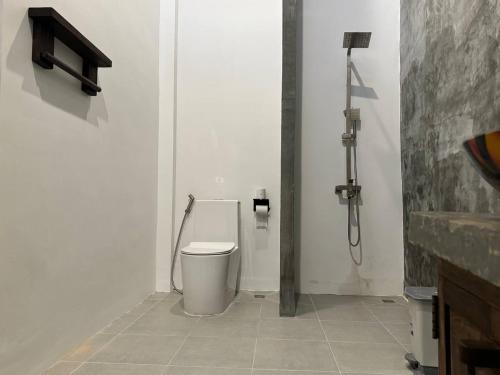 a bathroom with a toilet and a shower at STONE AGE Boutique in Kampot