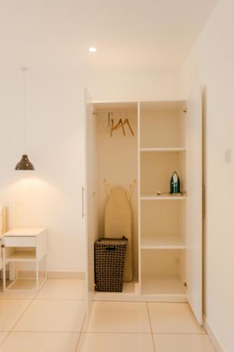 a room with white walls and a table and shelves at Accra Luxury Apartments at Embassy Gardens in Accra