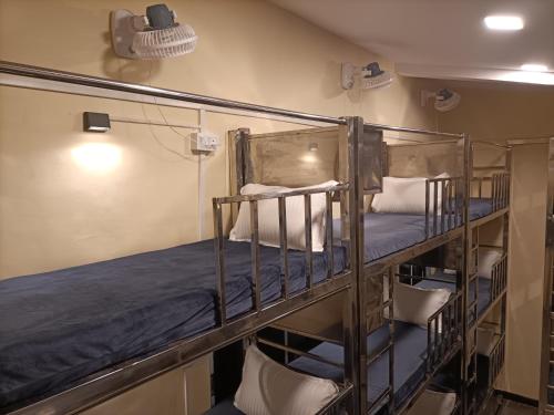 a couple of bunk beds in a room at The Aroma Backpackers in Mumbai