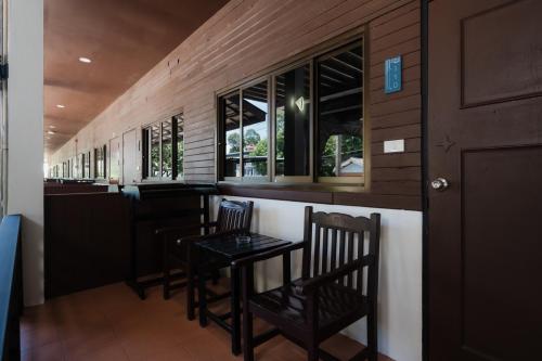 a bar with two chairs and a table in a room at C4 Resort in Koh Tao