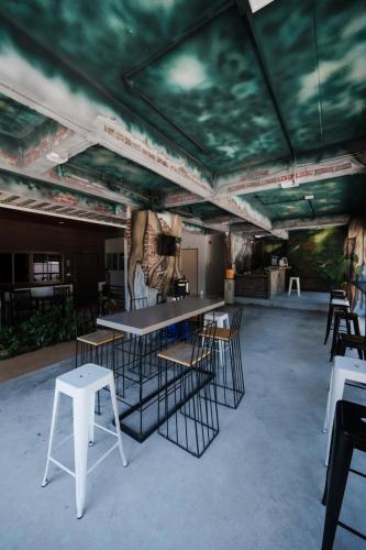 a room with a table and chairs in a room with a ceiling at C4 Resort in Koh Tao