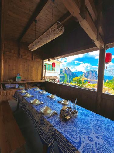 a dining table with a blue and white table cloth at Celestial Valley in Zhangjiajie