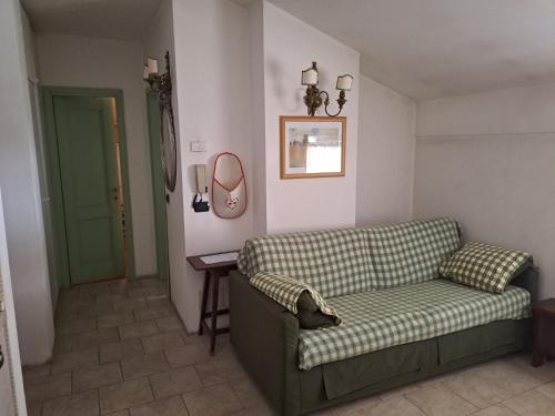 a living room with a couch and a table at Dolomiti House in Pinzolo