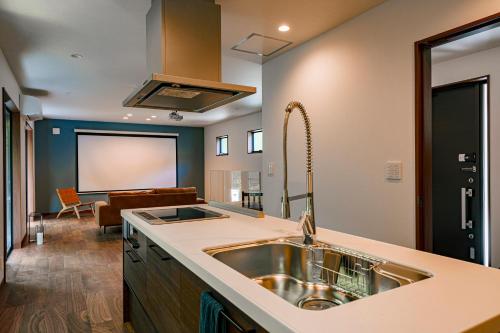 a kitchen with a sink and a living room at VILLA KAWAZU - Mori - in Shimo-sagano