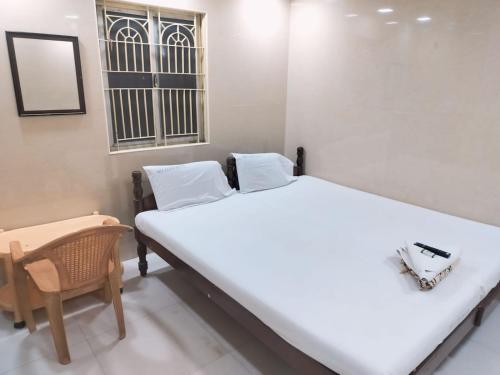 Ein Bett oder Betten in einem Zimmer der Unterkunft Hotel Mtc Guest House