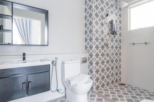 a bathroom with a toilet and a sink and a shower at The Arjana Resort in Masjid Tanah