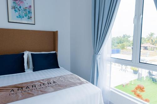 a bed in a room with a large window at The Arjana Resort in Masjid Tanah