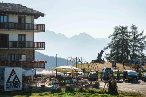 a building next to a parking lot with a playground at CHALET DES ALPES in Gressan