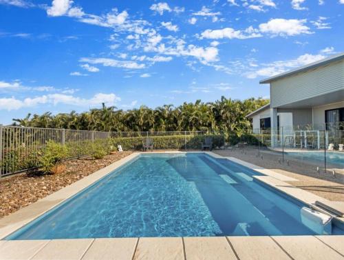 a swimming pool in the backyard of a house at Family home with Sea views in Urangan