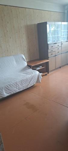 a bedroom with a white bed and a desk at Kalmāri 16 in Kolka