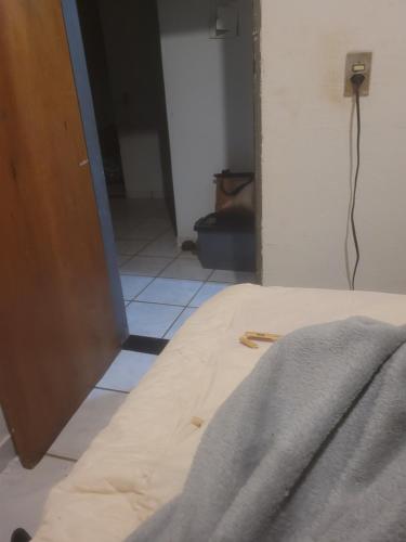 a view of a room with a bed and a hallway at Mineirohouse in Uberlândia