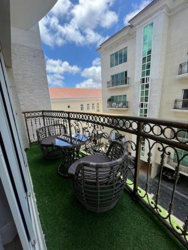 a balcony with tables and chairs and a fence at The Orai-3Bedroom Apartment in Lagos