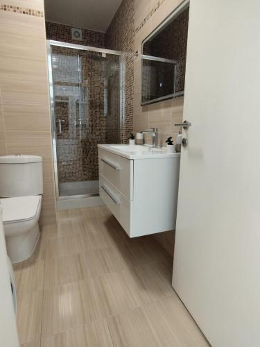 a bathroom with a white sink and a toilet at Apartman Skyroom in Banja Luka