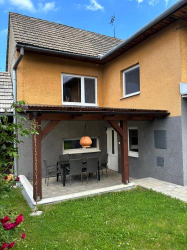 an outdoor patio with a table and chairs at Domček u strýka in Lazisko