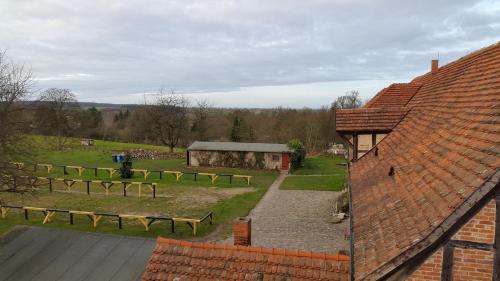 a view of a farm with a field and a building at Burghotel Stargard in Burg Stargard