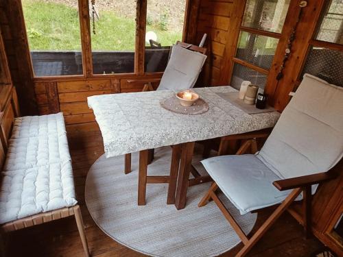 a table and two chairs in a room with a table and chairs at Bungalow in Göhren auf Rügen direkt am Strand in Göhren
