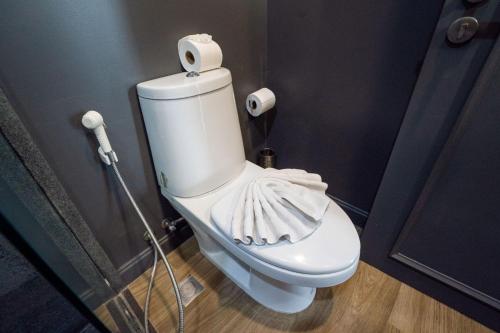 a white toilet in a bathroom with a mop at Spacious Pool Access Apartment with 2 BR - Rawai in Ban Saiyuan (1)