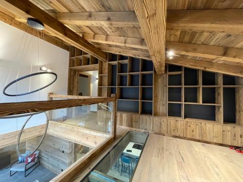 a glass floor in a room with wooden ceilings at Chalet L'Alpaga in Châtel
