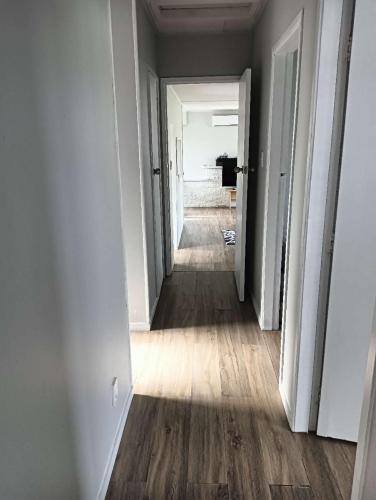 an empty hallway with a hallway leading to a room at 3 Bedroom House, 95 Aquirus Drive, Rotorua in Rotorua