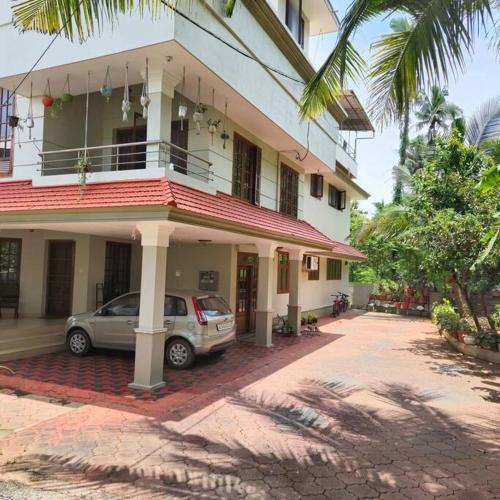 a car parked in front of a building at Meadows Serene Retreat in Kannur