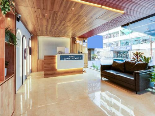 a lobby with a couch and a sign that reads the townhouse at Super Townhouse CASA GRAND in Hyderabad